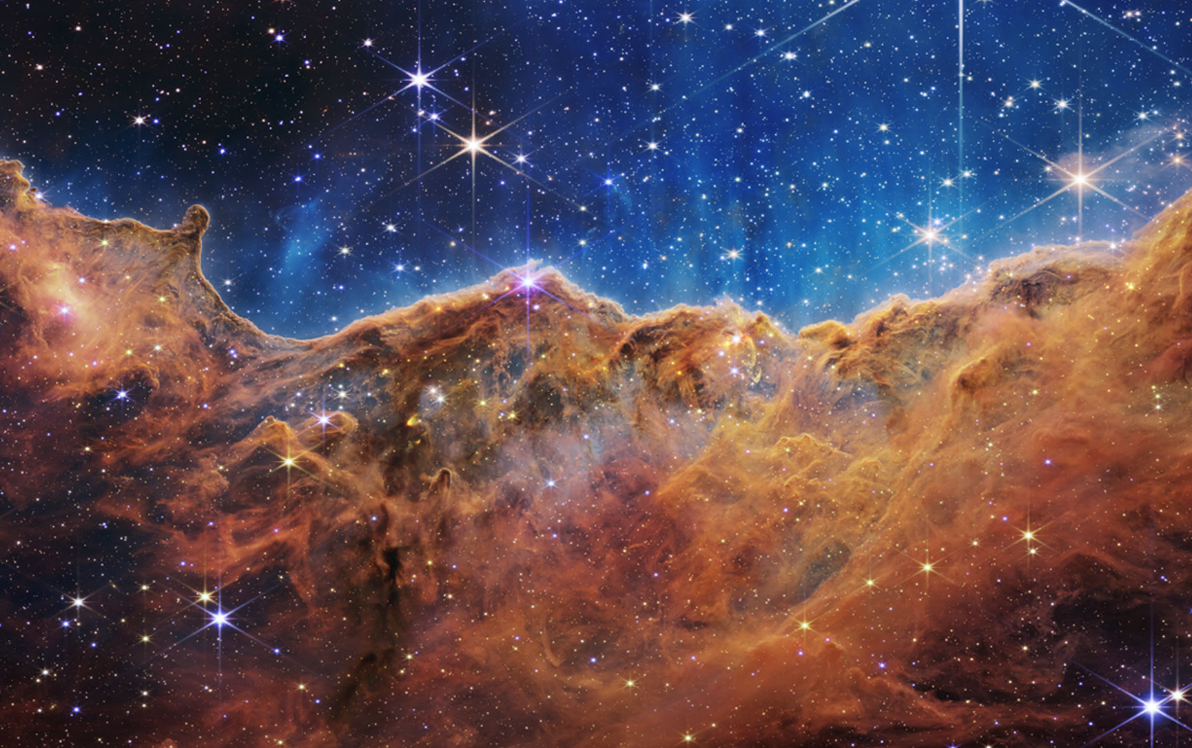 NASA’s Webb Reveals Cosmic Cliffs, Glittering Landscape of Star Birth